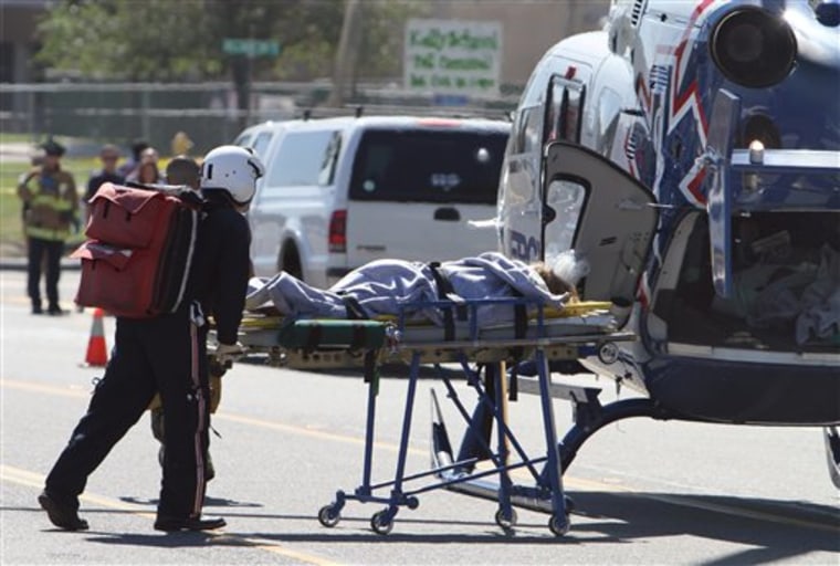 A injured student is wheeled to a helicopter after a lone gunman came on to the campus of nearby Kelly Elementary School, Friday, Oct. 8, 2010 in Carlsbad, Calif. Two children suffered arm wounds Friday when a man fired several shots toward a crowd of elementary school students before two witnesses tackled him, authorities said. (AP Photo/The North County Times, Hayne Palmour IV) SAN DIEGO UNION-TRIBUNE OUT; RIVERSIDE PRESS-ENTERPRISE OUT